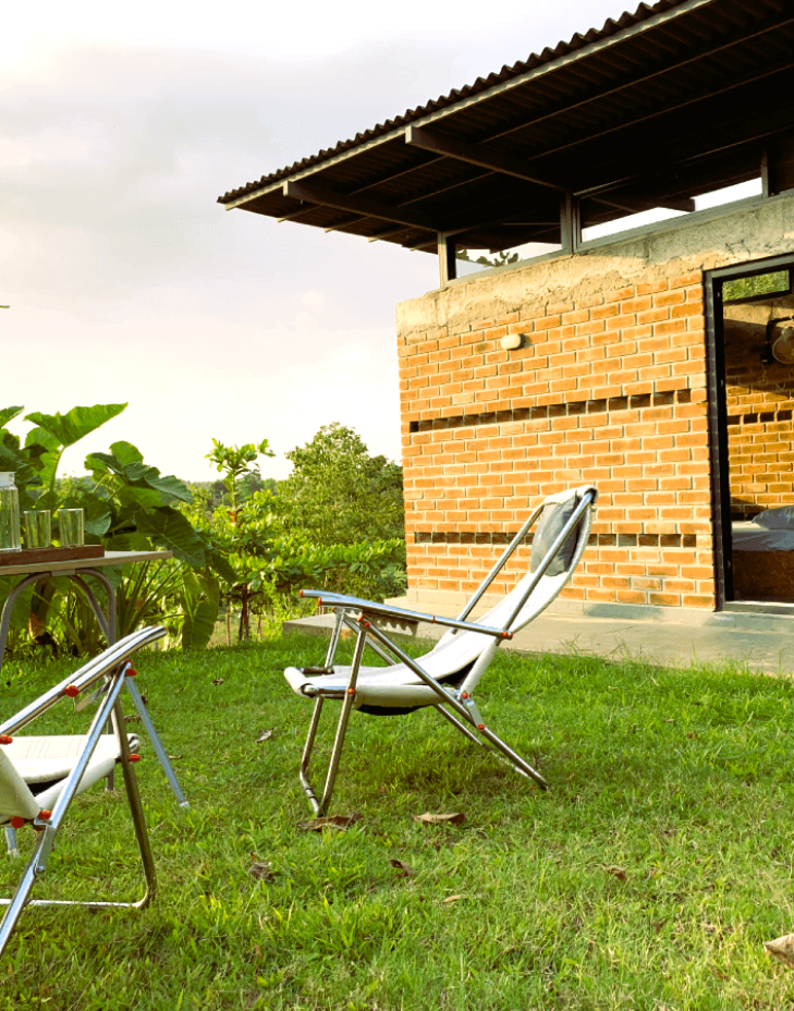 ecoland-farms-cottage-from-outside-with-2-rocking-chairs-1